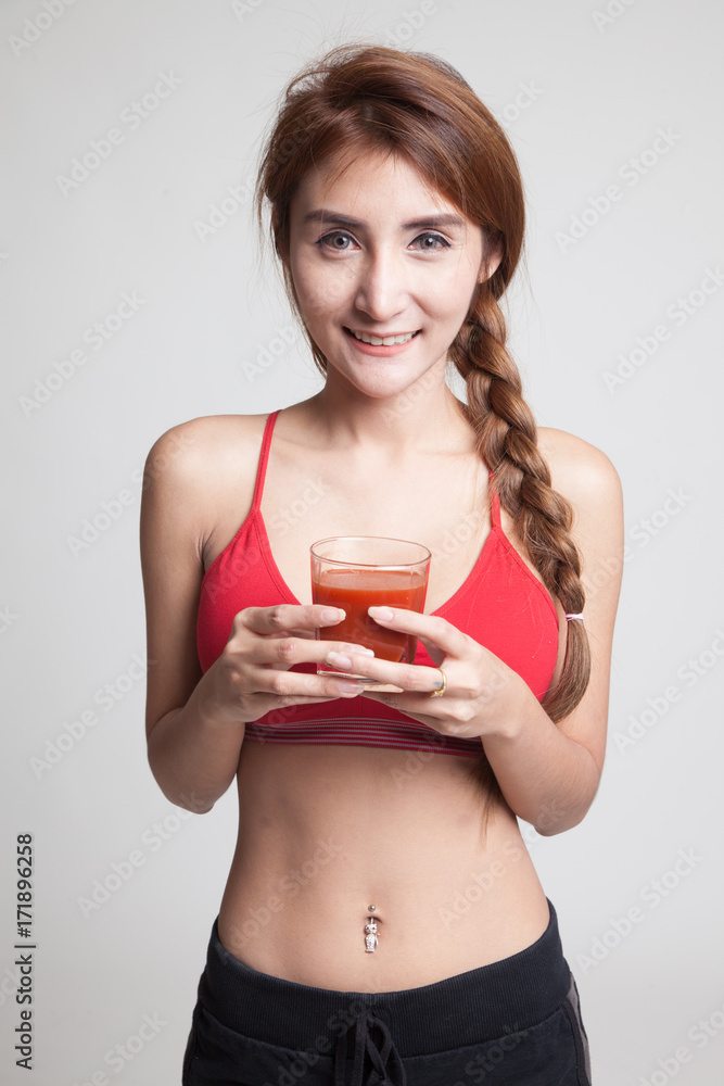 Beautiful healthy Asian girl with tomato juice. Beautiful healthy Asian girl with tomato juice.