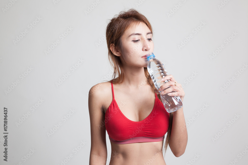 Beautiful Asian healthy girl with bottle of drinking water. Beautiful Asian healthy girl with bottle of drinking water.