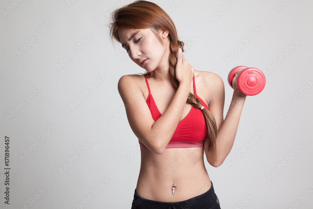 Asian healthy girl got shoulder pain with dumbbell. Asian healthy girl got shoulder pain with dumbbell.