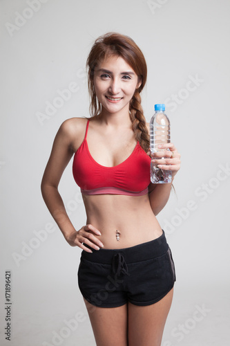 Beautiful Asian healthy girl with bottle of drinking water. © halfbottle