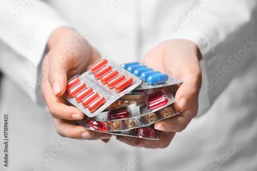 Woman holding blisters with pills, closeup