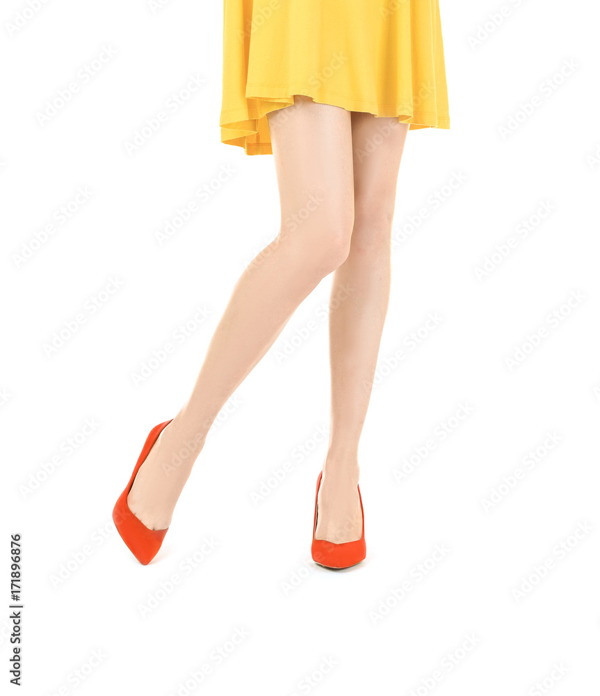 Young woman wearing dress and high heels on white background Young woman wearing dress and high heels on white background