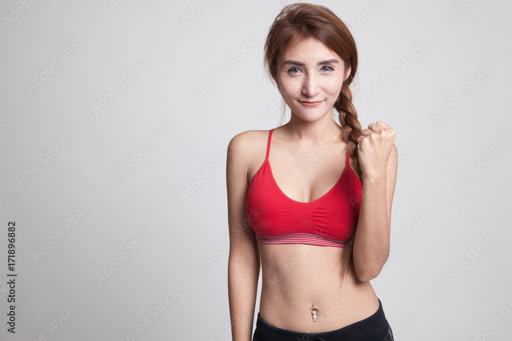 Fototapeta premium Successful young Asian woman in sport dresses hold fist up.
