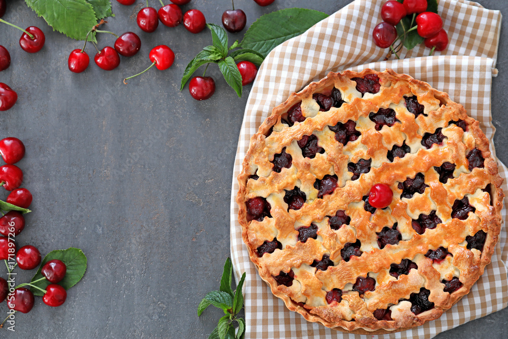 Composition with tasty cherry pie on gray table Composition with tasty cherry pie on gray table