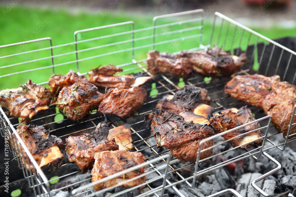 Cooking of appetizing juicy spare ribs outdoors Cooking of appetizing juicy spare ribs outdoors