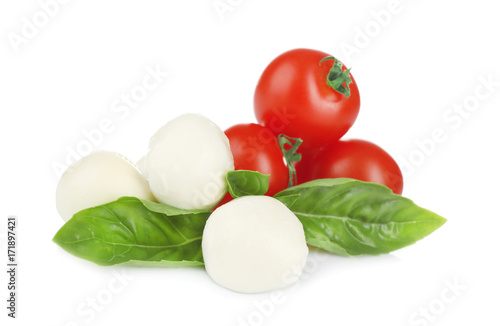 Mozzarella cheese balls, cherry tomatoes and green fresh organic basil isolated on white