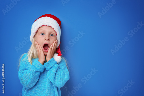 Cute girl in Santa hat on c...