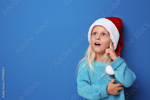 Cute girl in Santa hat on c...
