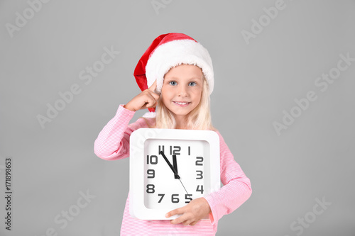 Cute girl in Santa hat with...
