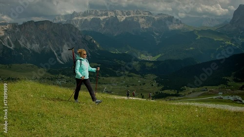 Hikers walk along the trail in Alps. Hiking is a wonderful pastime in highlands photo