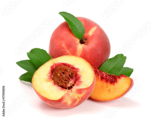 Peach and half with a green leaf isolated on white background