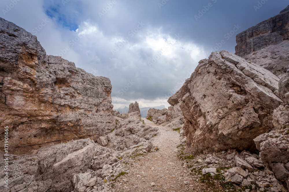 Fototapeta premium Path in the middle of giant boulders, Dolomites, Cortina d'Ampezzo, Italy