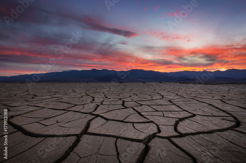Beautiful sunset with cracked and scorched foreground in Death Valley