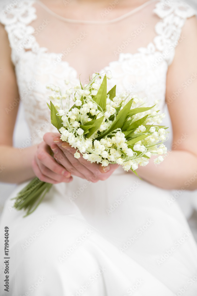 wedding white bouquet in bride's hands white background wedding white bouquet in bride's hands white background