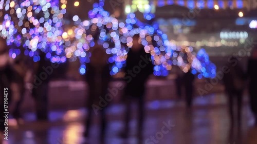 Christmas background. People walking in the city 