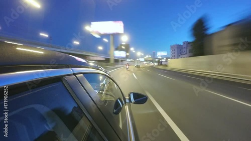 Driving at high speed through the night city highway. Pov blurred timelapse with view from outside of the cabin.