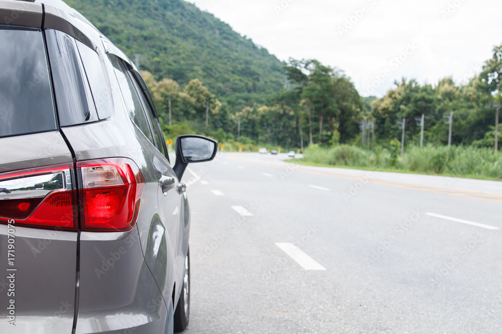 Car parked inside road with mountain background