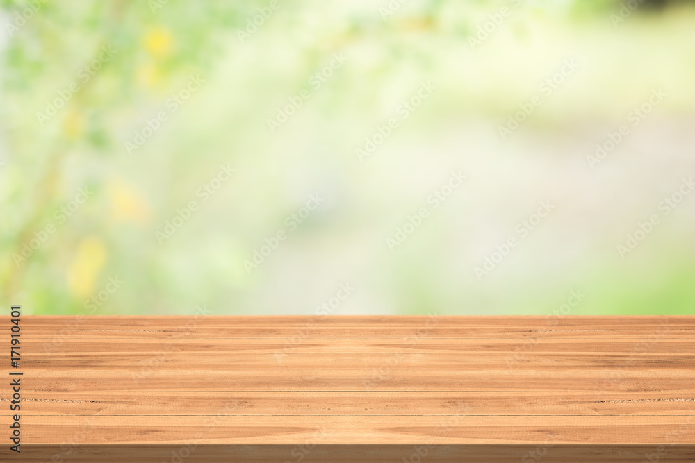 Wood table top on nature green blurred background,for montage your products Wood table top on nature green blurred background,for montage your products