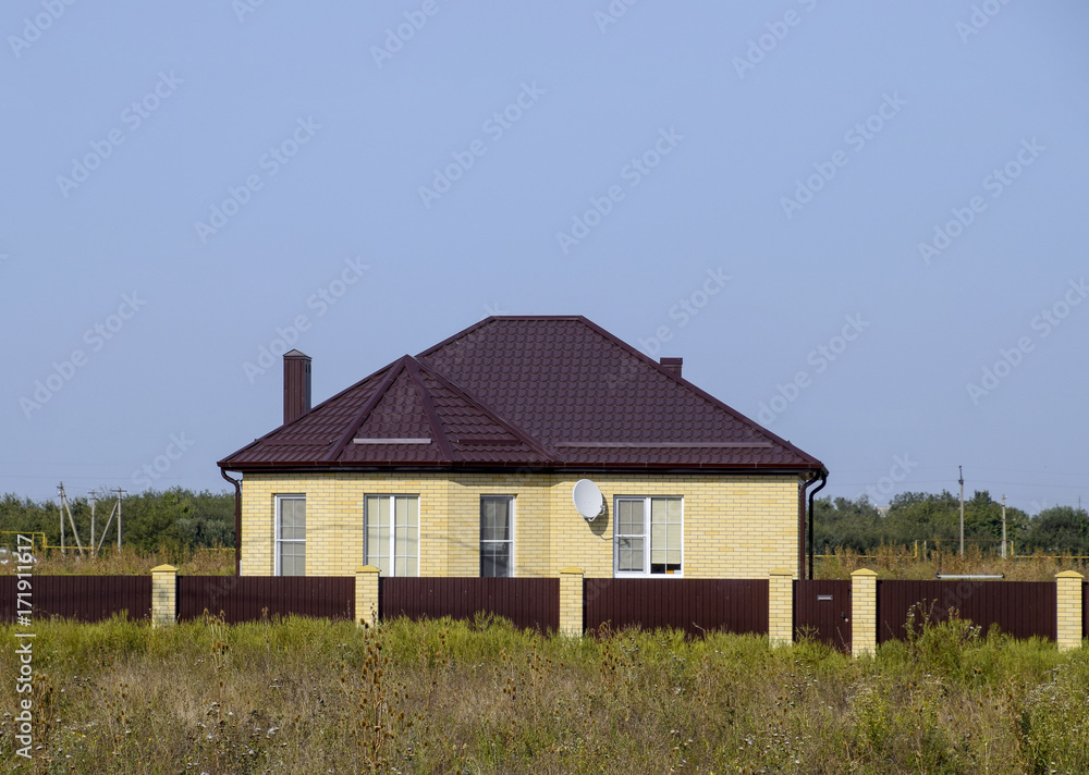 The house with plastic windows and a roof of corrugated sheet The house with plastic windows and a roof of corrugated sheet