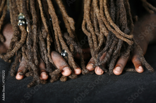 Conceptual image of Hands of African-American man and dreadlocks  photo