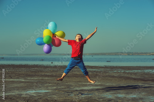 happy boy with balloons on nature.Kids activities