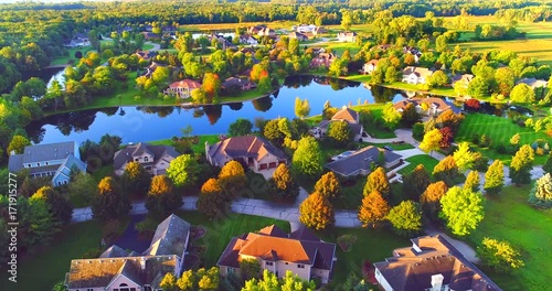 Beautiful neighborhoods, homes in Autumn, around lakes, aerial view, dawn. photo