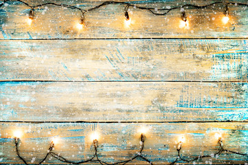 Christmas lights bulb on wood table. Merry christmas (xmas) background. topview, border design - rustic and vintage styles