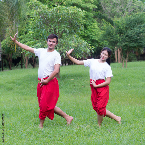 Asian young boy and girls learning Thai dance. Classical Dance in white shirt red loincloth, Demonstrate dance in the garden