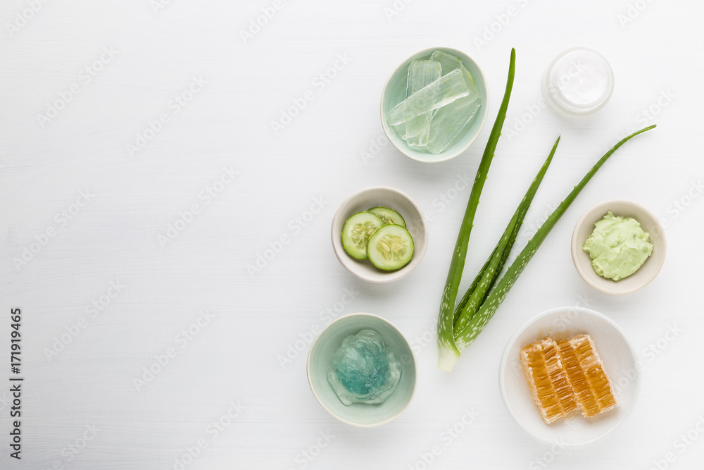 Homemade herbal dermatology cosmetic hygienic cream for beauty and skincare product. honey, cucumber, aloe vera, salt, mint on white background. Homemade herbal dermatology cosmetic hygienic cream for beauty and skincare product. honey, cucumber, aloe vera, salt, mint on white background.