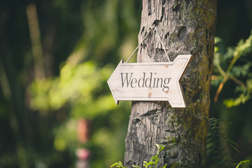 Soft focus vintage wedding sign. Handmade wooden board with the inscription Wedding