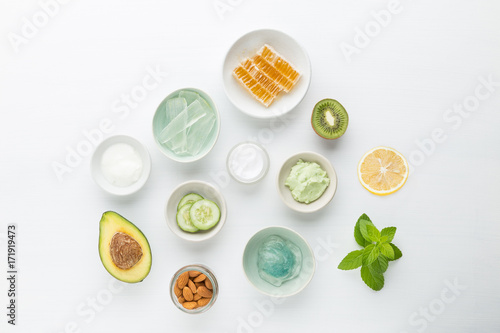 Herbal dermatology cosmetic hygienic cream for beauty and skincare product. honey, almond, kiwi, cucumber, aloe vera, avocado, salt, mint, yogurt on white background.