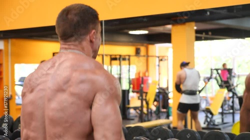 athlete bodybuilder is engaged in the gym. 4k slow motion photo