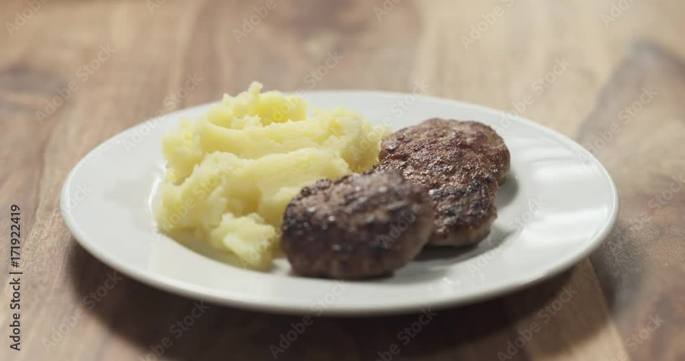 focus pull mashed potatoes with cutlets on white plate focus pull mashed potatoes with cutlets on white plate