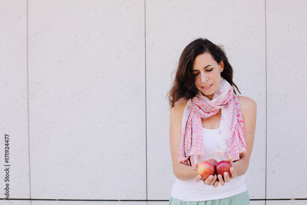 Beautiful woman is holding with freshly organic red apples Beautiful woman is holding with freshly organic red apples
