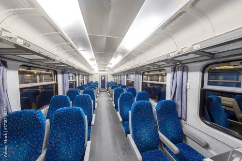 Empty train interior with blue chairs