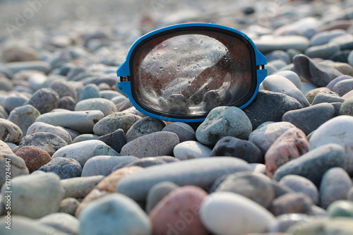 mask for scuba diving on a pebble beach