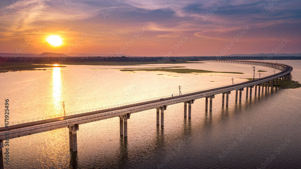 Railroad bridge Over River Pa Sak Dam Lopburi Thailand and Beautiful sunset