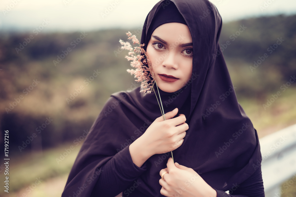 Fashion portrait of young beautiful muslim woman with the black
