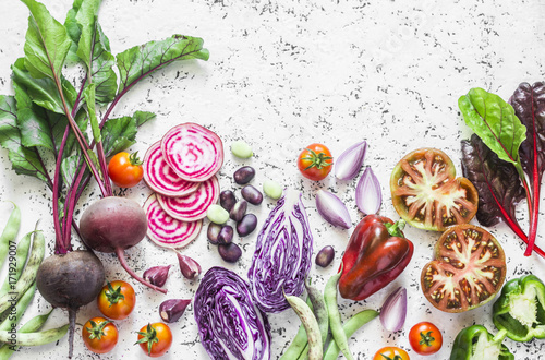 Variety of vegetables a light background. Beets  red cabbage  beans  tomatoes  red onions  peppers food background. Vegetarian food concept