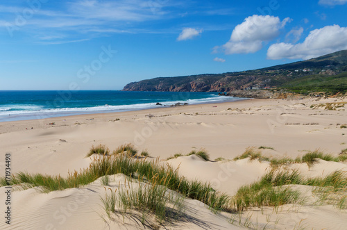 Costal view of Praia do Guincho (Guincho Beach) located on Estoril coast near the town of Cascais, Portugal. This is popular blue flag Atlantic beach for surfing, windsurfing, and kitesurfing