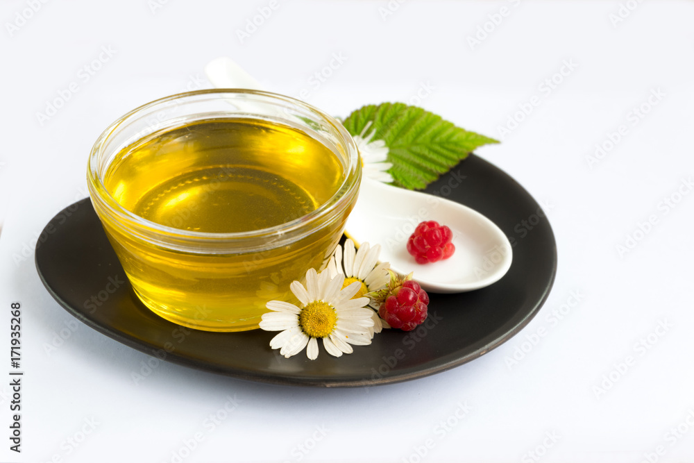 Honey on white background in jar, glass. Chamomile, raspberry. Honey on white background in jar, glass. Chamomile, raspberry.
