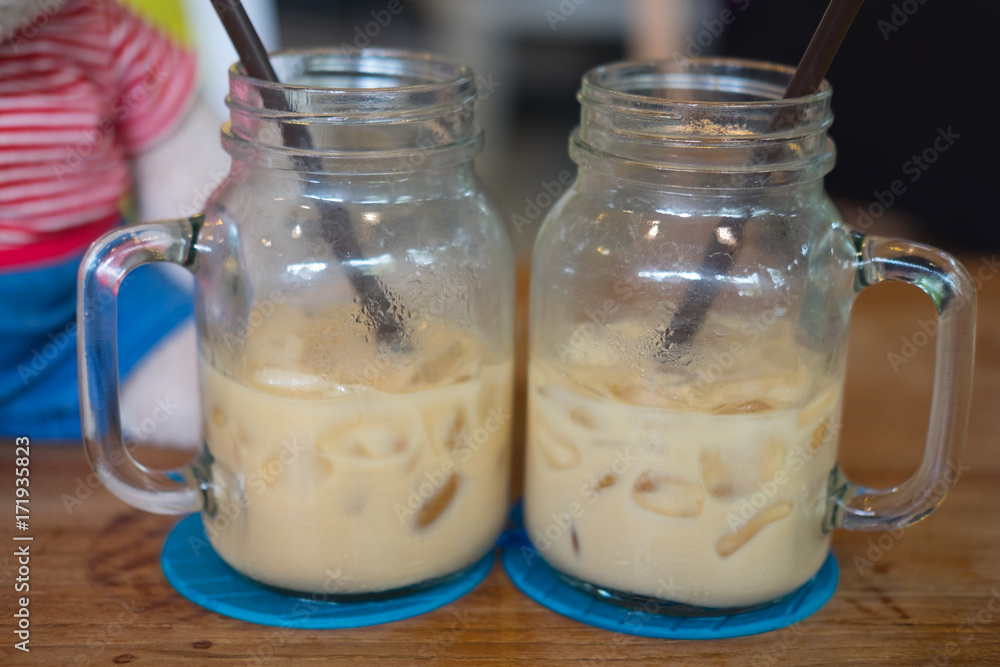 Glass mason jar with ice coffee Glass mason jar with ice coffee