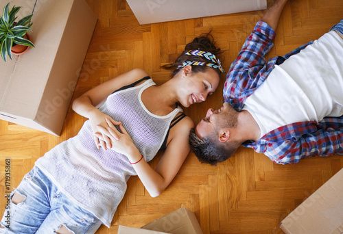 Bilde på lerret Moving in new home. Couple laying on the floor.