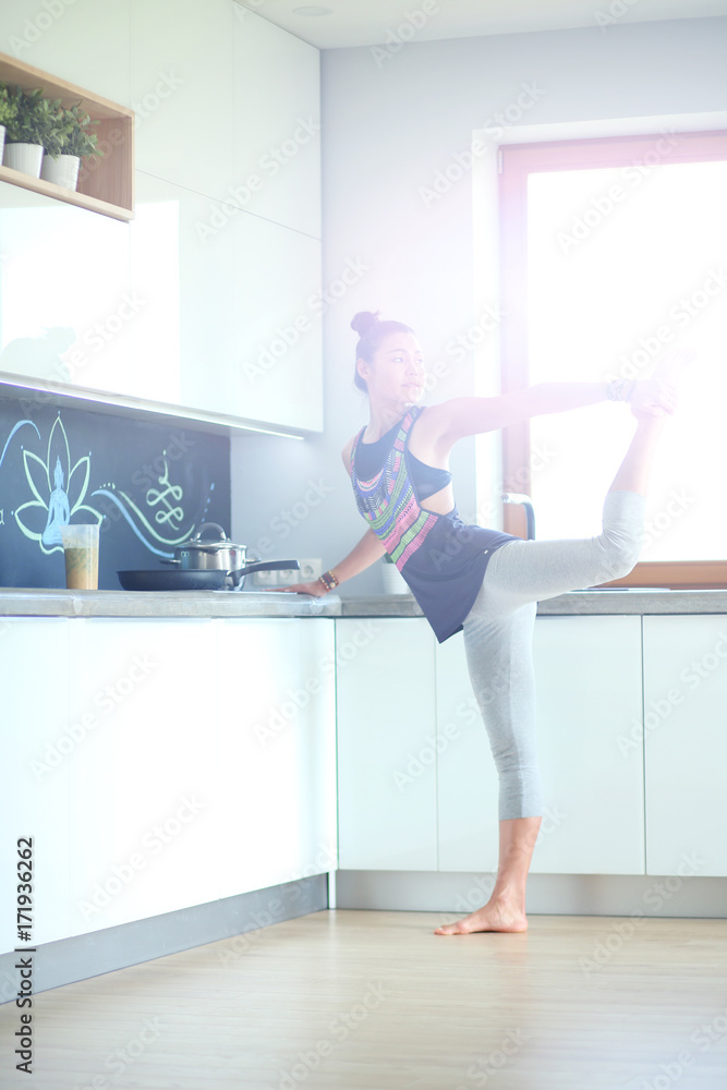 Fitness girl cooking healthy food in the kitchen. Woman. Kitchen. Cooking Fitness girl cooking healthy food in the kitchen. Woman. Kitchen. Cooking
