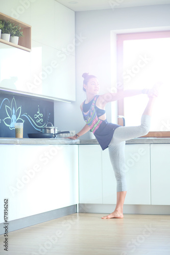 Fitness girl cooking healthy food in the kitchen. Woman. Kitchen. Cooking