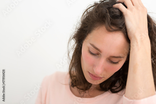 Young woman having a headache due to stress and anxiety - Burn out concept