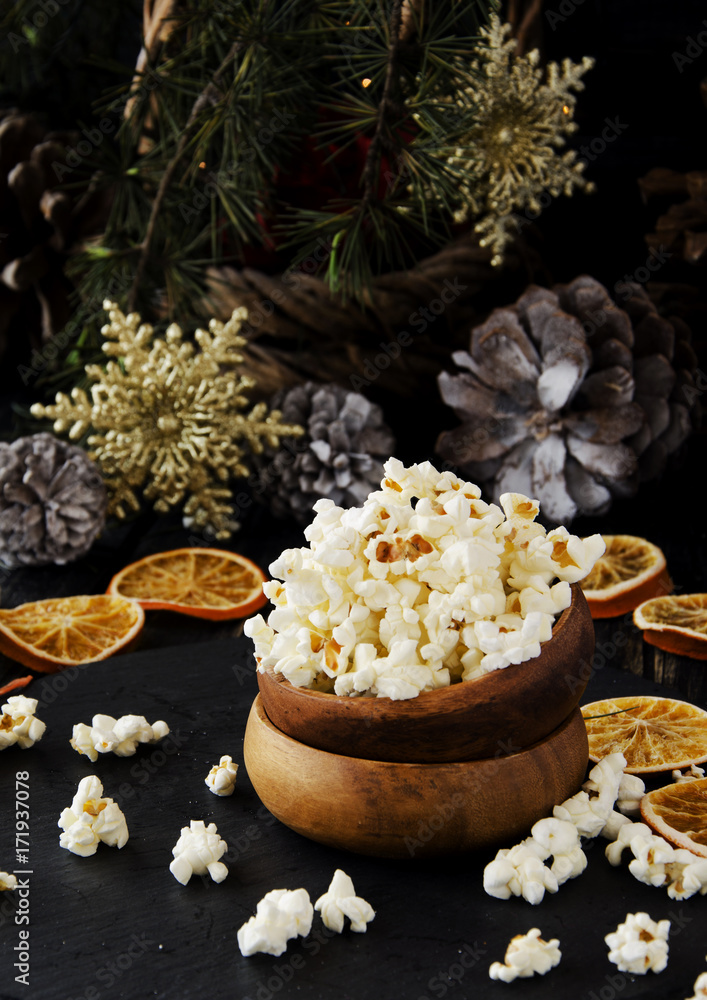 popcorn in a wooden plate on the background of Christmas popcorn in a wooden plate on the background of Christmas