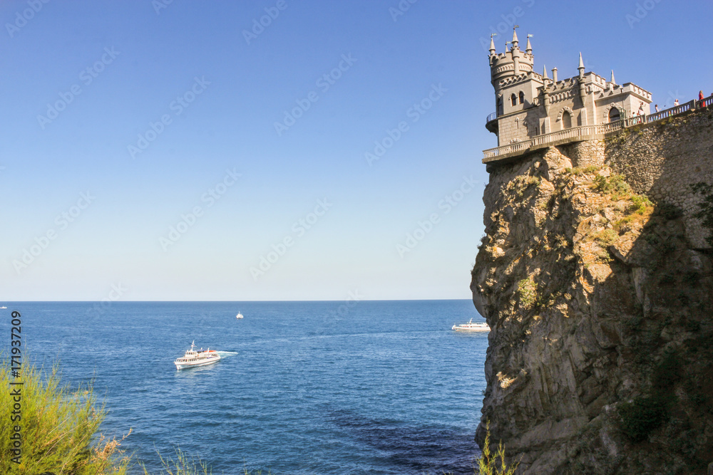 Castle on a rocky shore.