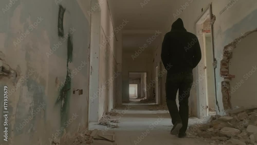 Hooded young man inside destroyed abandoned building,slow motion,dramatic.A sad young man facing social issues, walking inside a big wrecked empty building in slow motion.Drone/dolly motion. Hooded young man inside destroyed abandoned building,slow motion,dramatic.A sad young man facing social issues, walking inside a big wrecked empty building in slow motion.Drone/dolly motion.