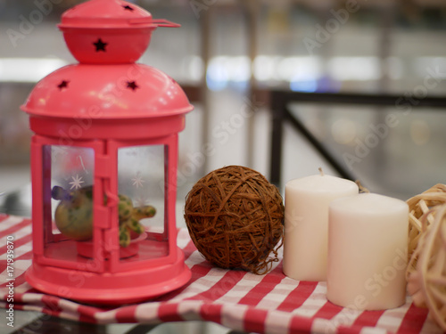lantern candle and alarm clock with red and white fabric artificial flowers bouquet home decoration concept on bokeh background